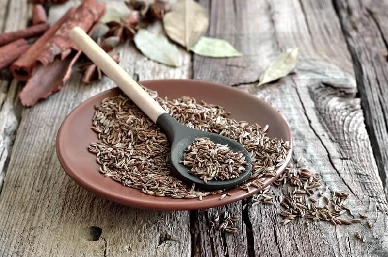 cumin seeds and spoon
